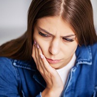 Female holding her mouth in pain