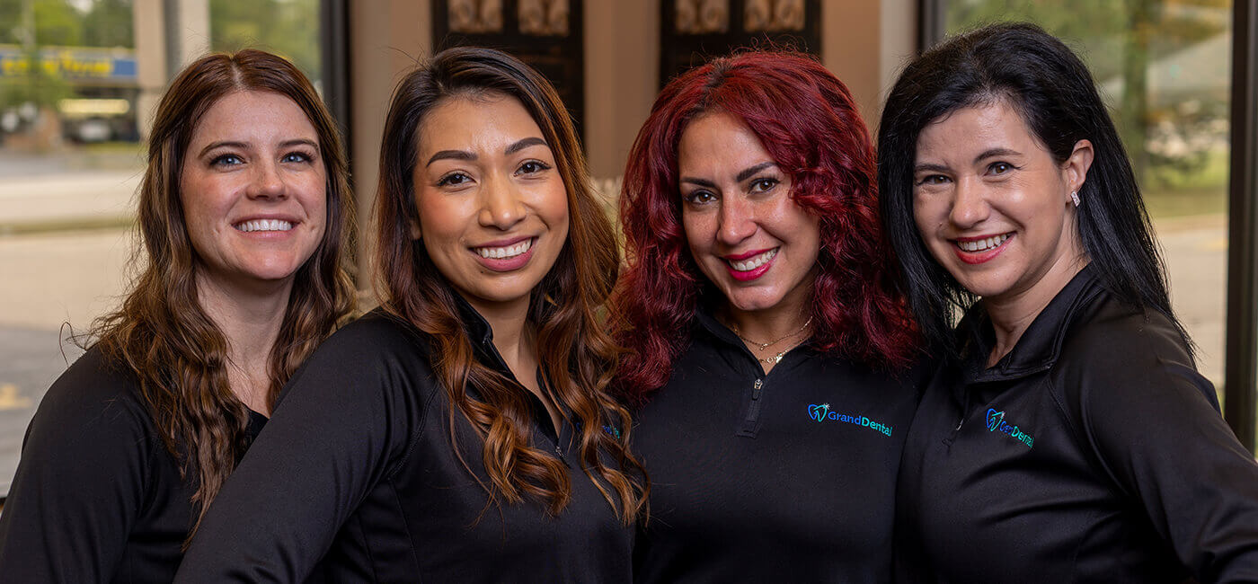 Woman checking in at dental office reception desk