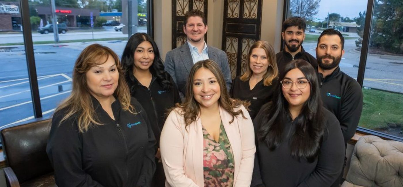 Woman checking in at dental office reception desk