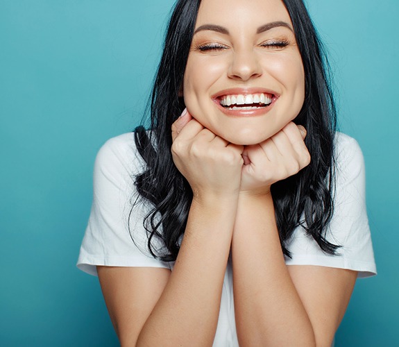 Woman with flawless smile after metal-free dental restorations