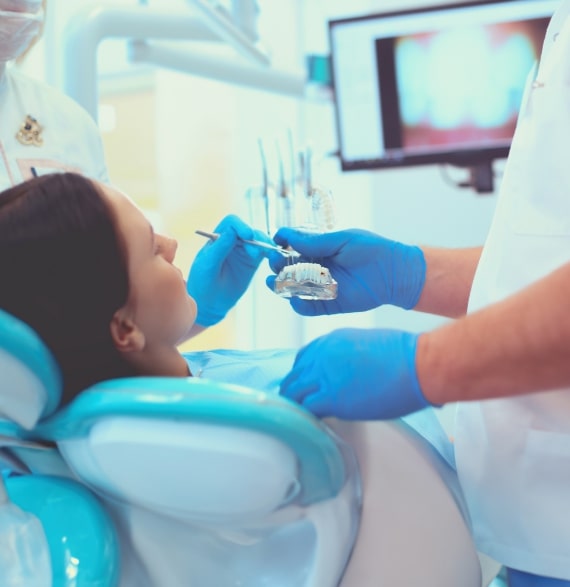 Dentist taking to young patient