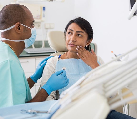 Woman listening to emergency dentist in Lake Zurich