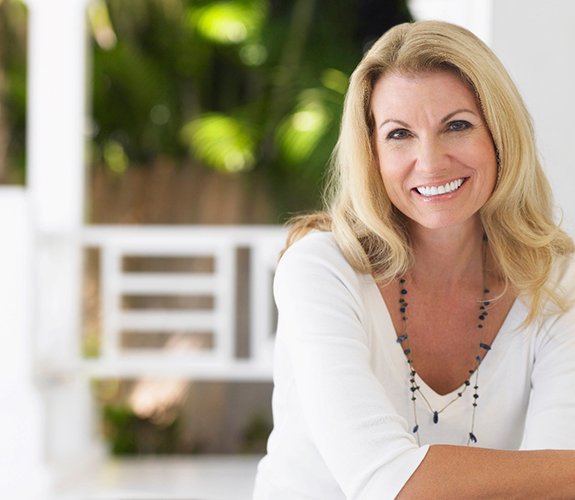 Beautiful middle-aged woman with dental implants in Lake Zurich