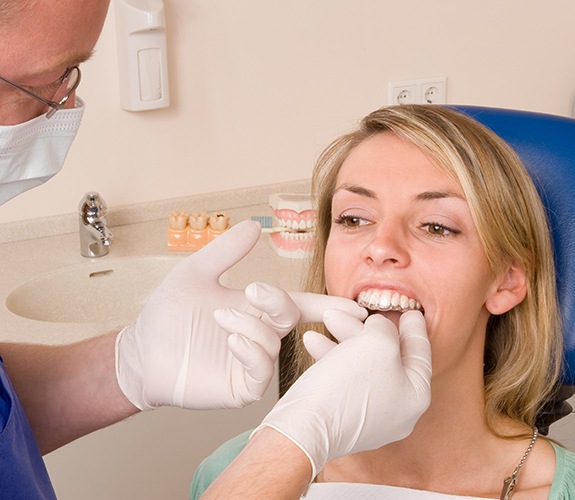Dentist checking the fit of a patient's Invisalign tray