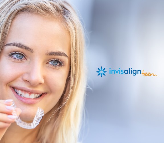 Teen girl holding an Invisalign tray