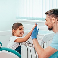 Young child high-fiving the dentist