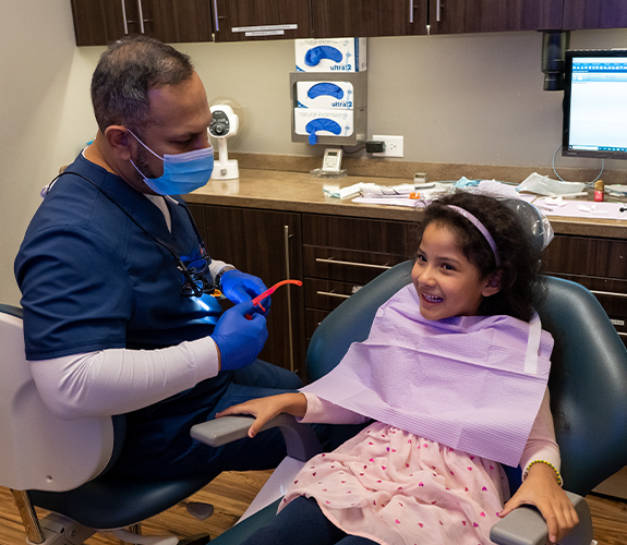 Child sharing smile after receiving dental sealants