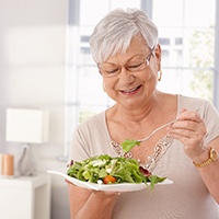 Older woman eating a salad