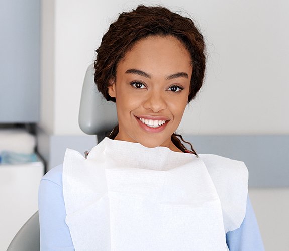 Woman showing off beautiful smile after dental cleaning