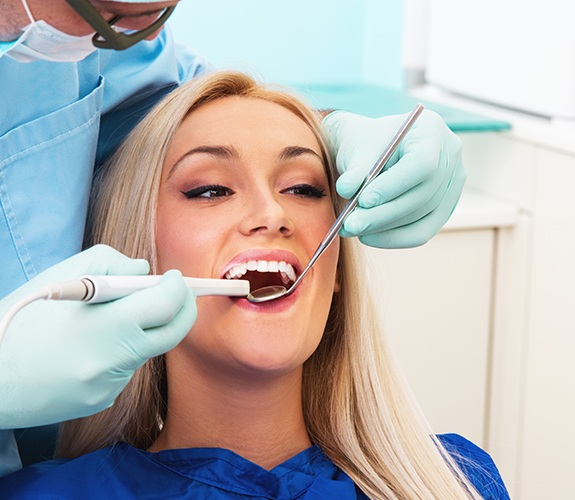 Woman receiving oral cancer screening