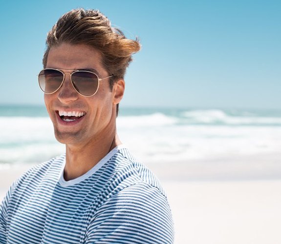 Man smiling while on the beach