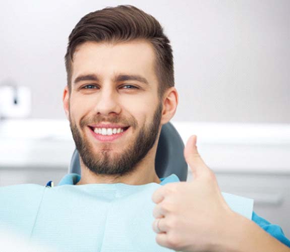 Man giving thumbs up after scaling and root planing in Lake Zurich