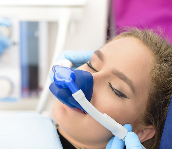 Woman with nitrous oxide dental sedation mask in place
