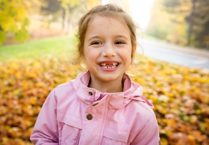 Young girl with healthy smile after children's dentistry visit