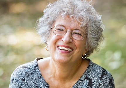 Older woman  smiling after replacing missing teeth