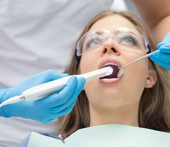 Dentist using intraoral camera to capture images of a patient's smile