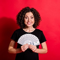 Woman smiling and holding money