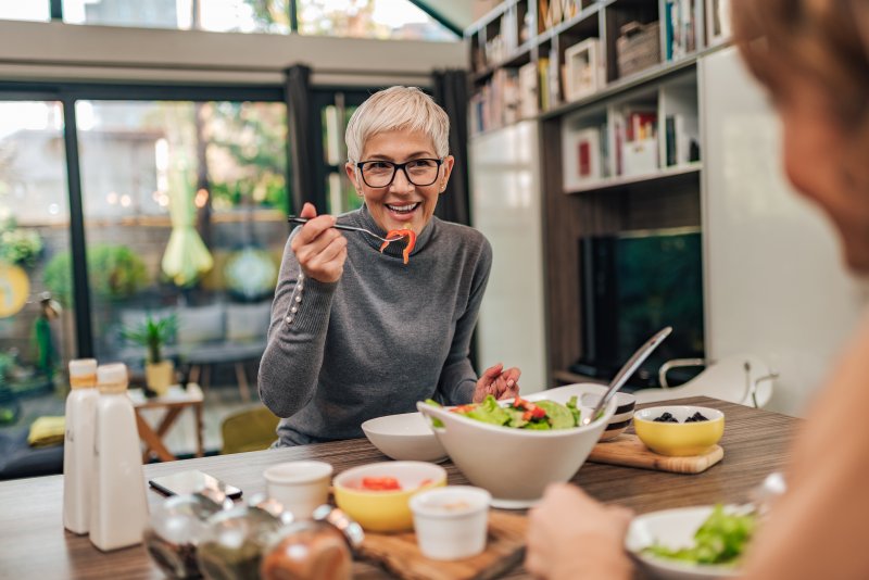 woman eating with dentures