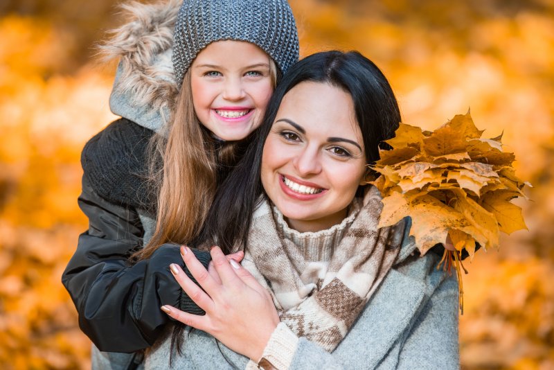 woman and child in the fall