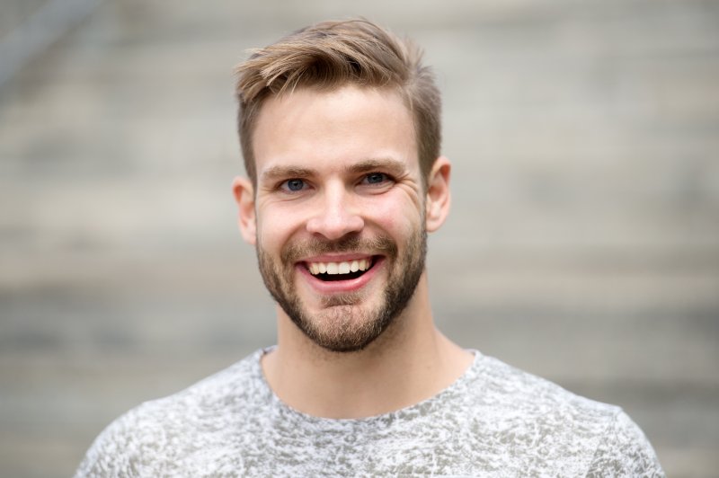 man smiling with dental implants