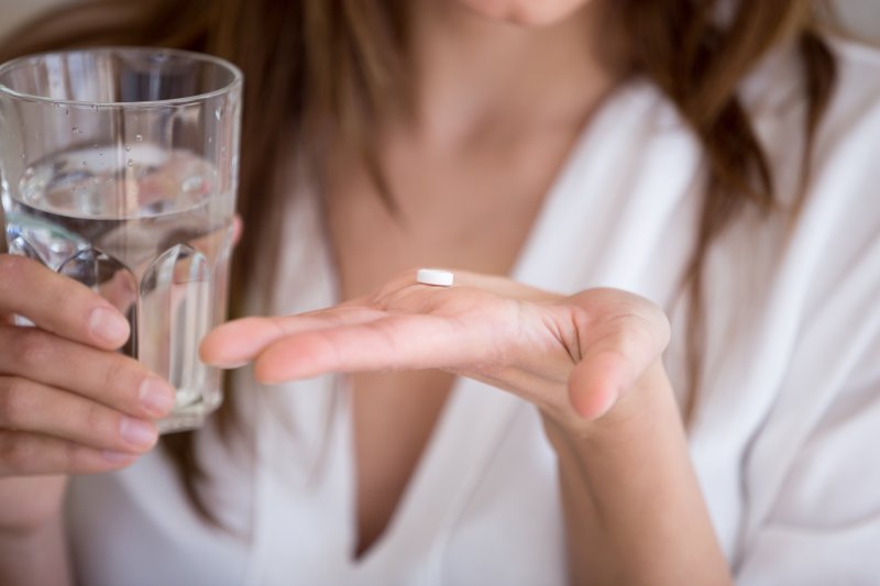 person preparing to take oral medication